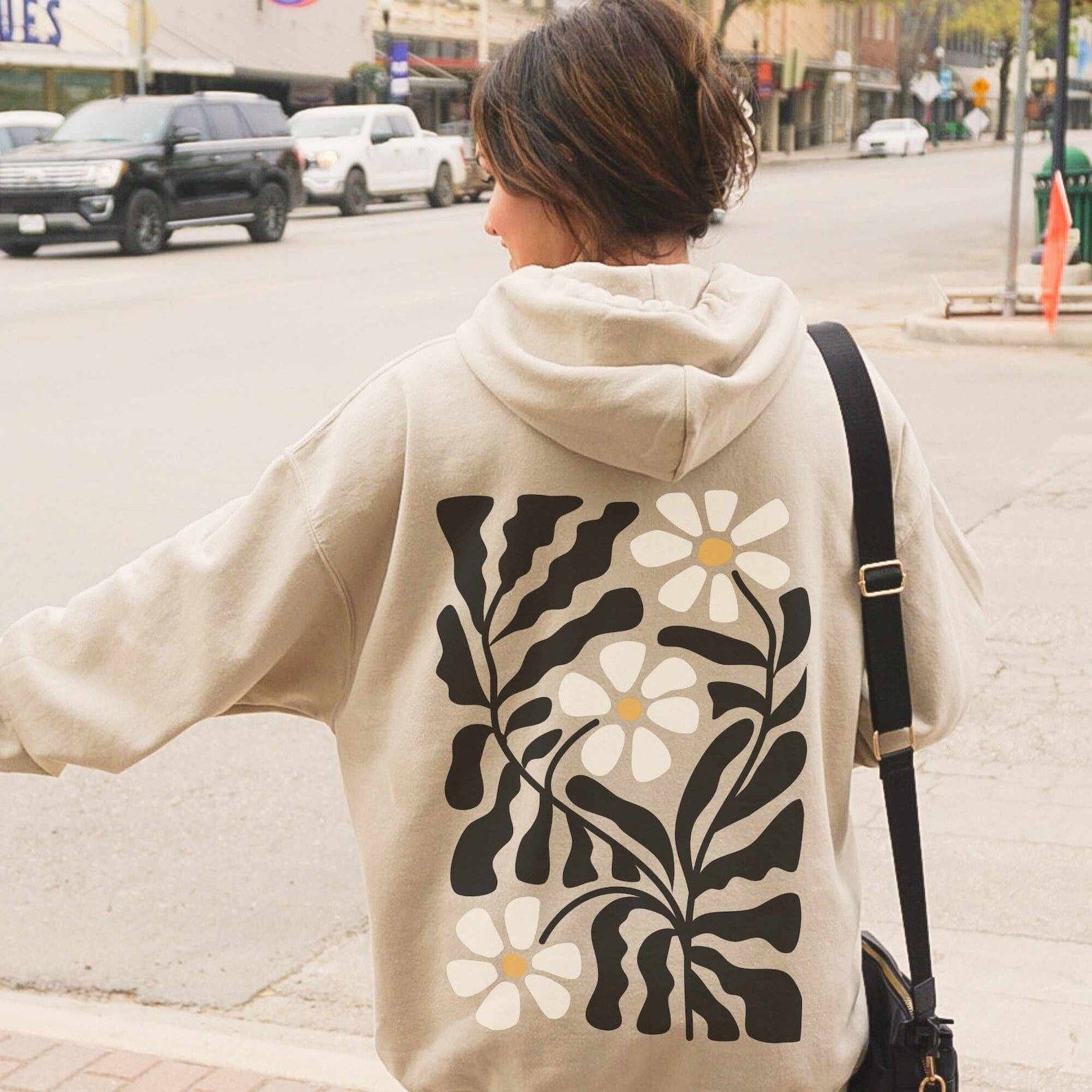 Tan boho floral hoodie with design of groovy flowers on the back