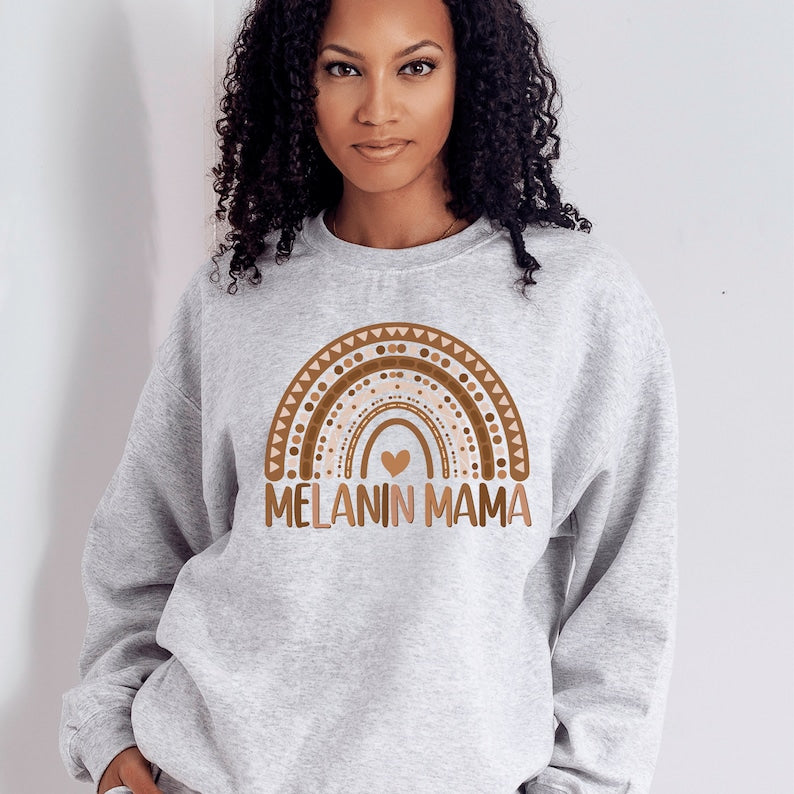 light gray  unisex melanin mom sweatshirt with a graphic of a rainbow in shades of brown with the words melanin mama underneath the rainbow