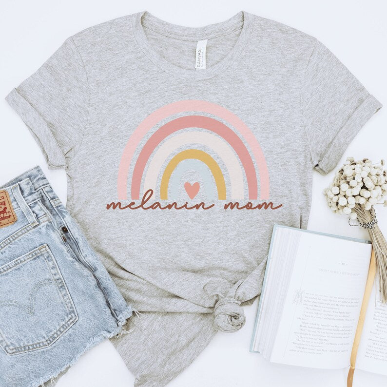 light gray nisex melanin mom shirt with a rainbow that says melanin mom underneath