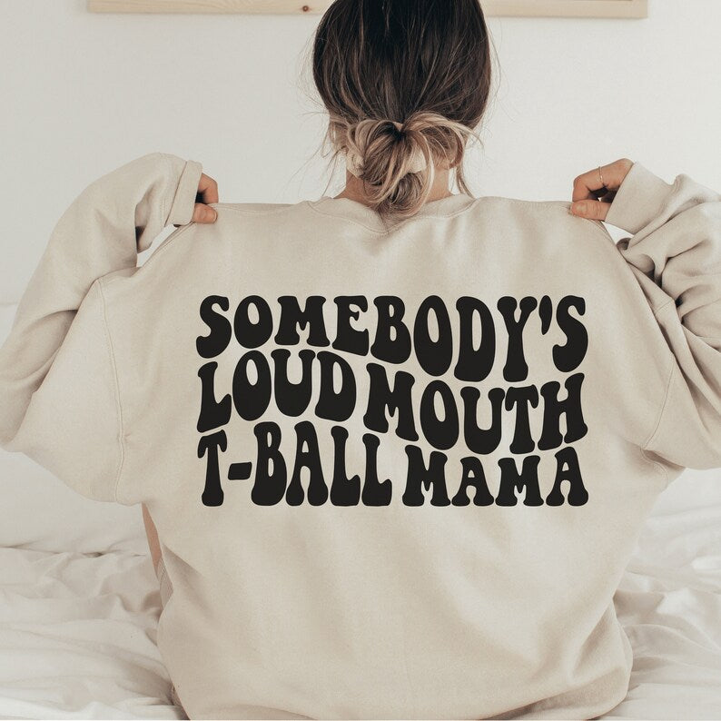 beige  unisex tball mom shirt that says somebody's loudmouth t-ball mama