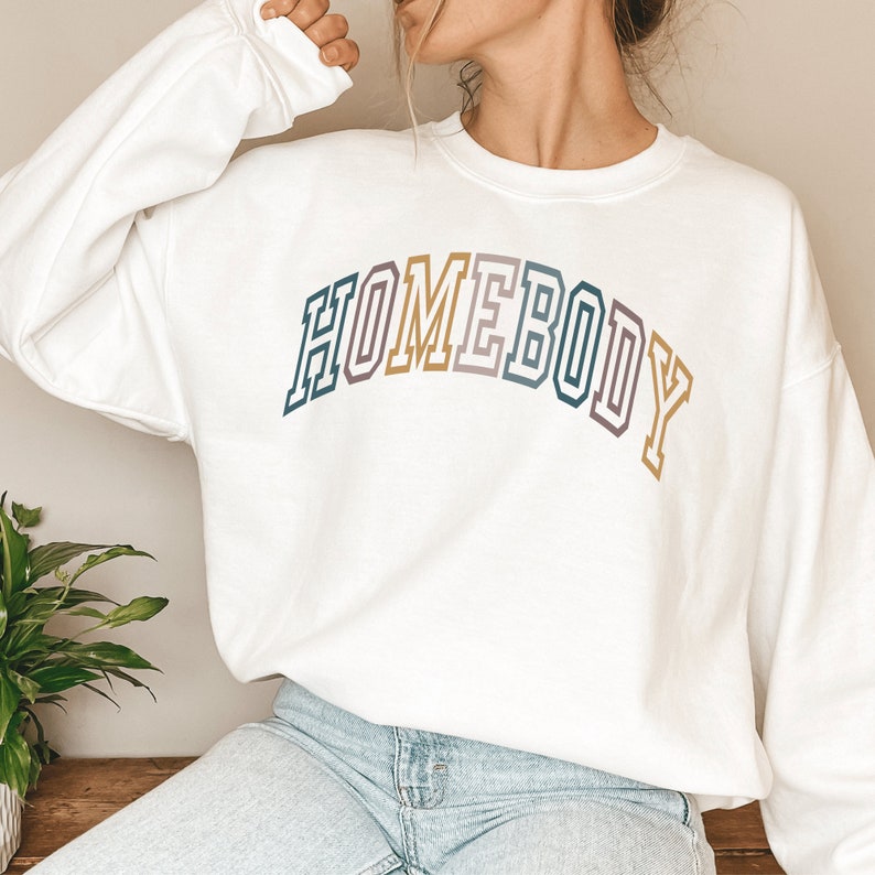 homebody sweatshirt, with the word homebody in multicolor lettering and college style font