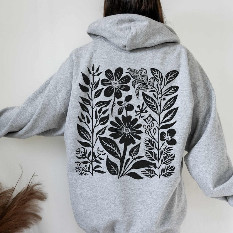 Gray floral hoodie with black wildflower design on the back.
