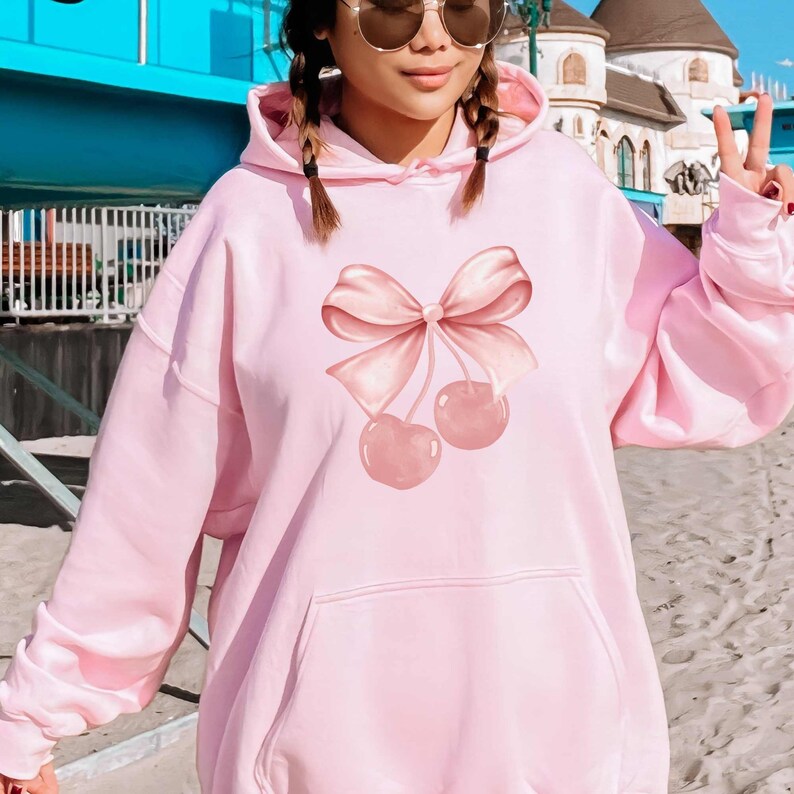 pink bow hoodie with cherry ribbon design on front of hoodie