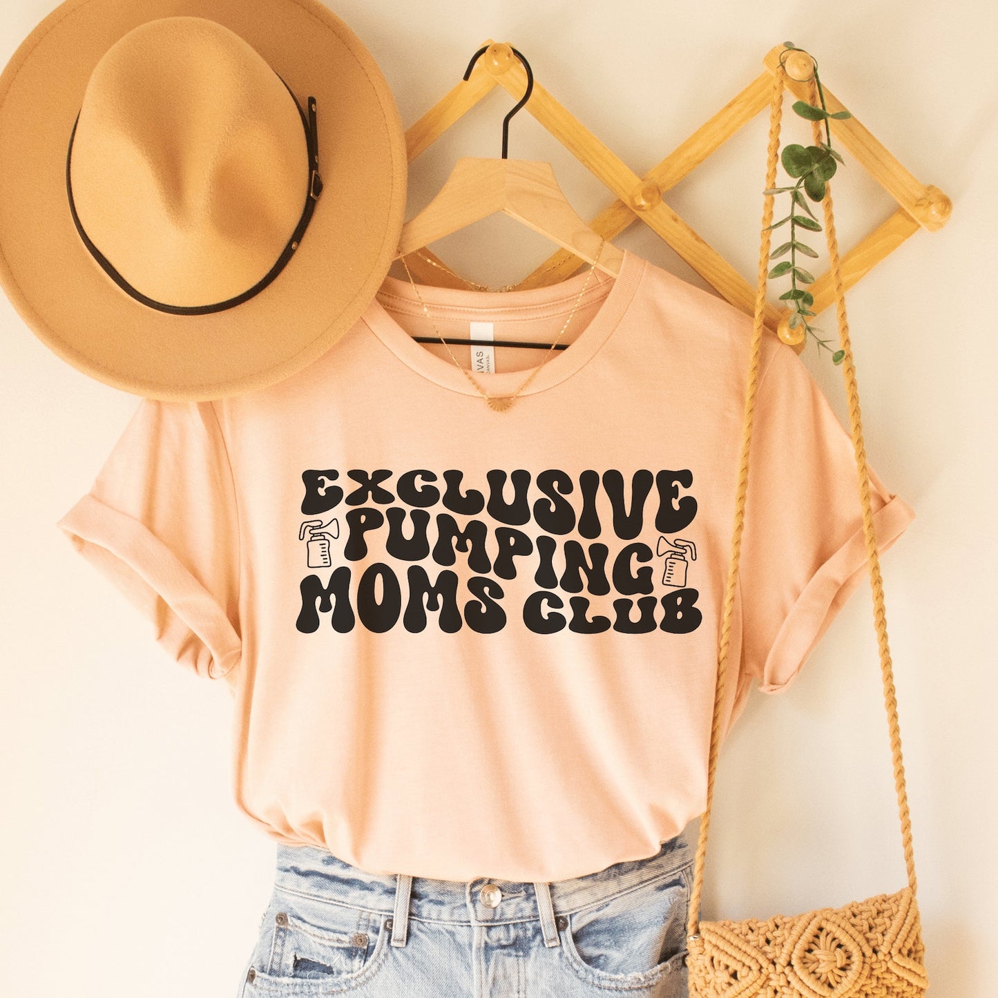 heather peach unisex funny breastfeeding shirts that says exclusive pumping moms club in retro styled black letters