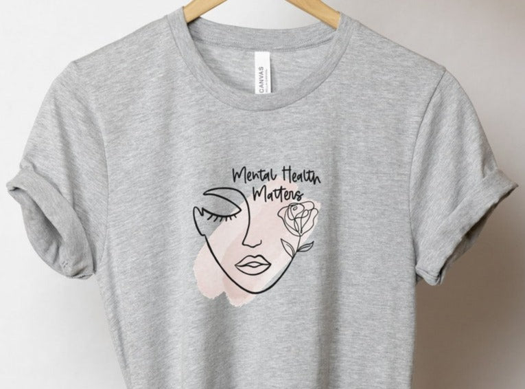 gray unisex mental health matters shirt with line art graphic of woman and the phrase mental health matters