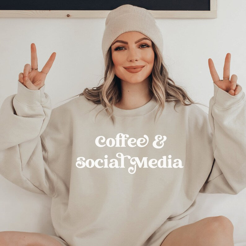 beige unisex sweatshirt that says coffee and social media, great gifts for social media managers