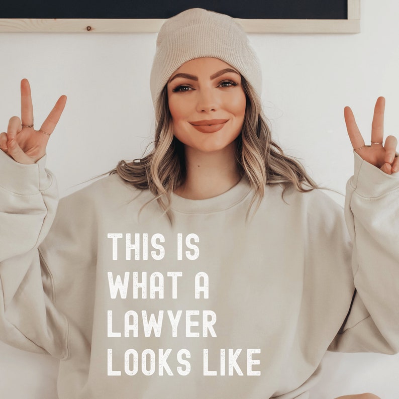 beige unisex lawyer sweatshirt that says this is what a lawyer looks like