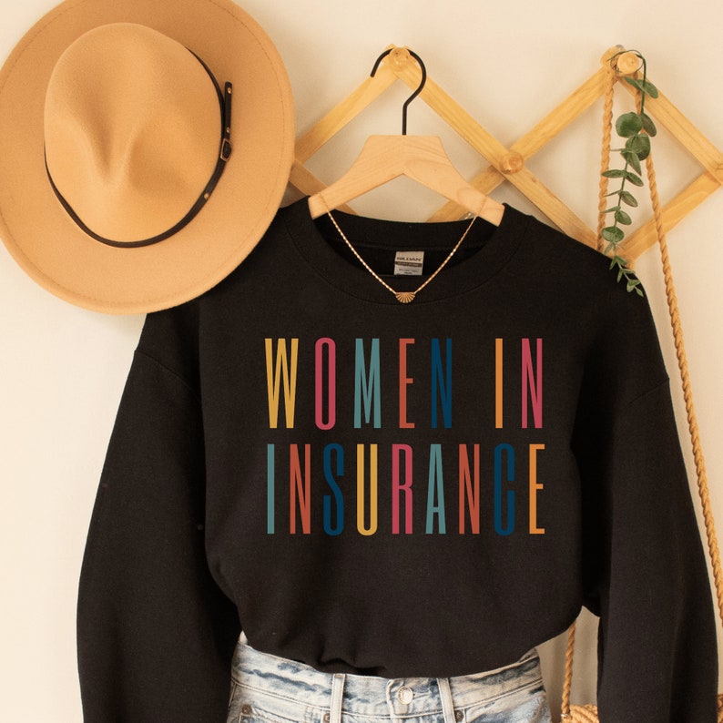 black unisex sweatshirt that says "women in insurance" in all capital, multicolored letters and makes the perfect gift for an insurance agent