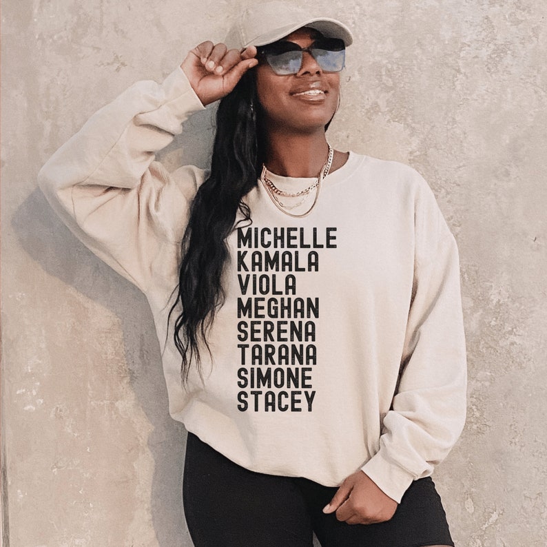 beige unisex melanin sweatshirt that says michelle, kamala, viola, meghan, serena, tarana, simone, stacey in all black capital letters