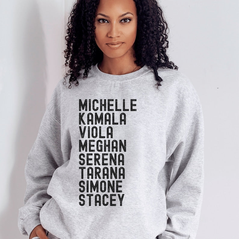 light gray unisex melanin sweatshirt that says michelle, kamala, viola, meghan, serena, tarana, simone, stacey in all black capital letters