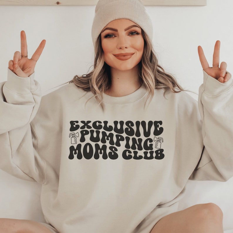 beige unisex breastfeeding sweatshirt that says exclusive pumping moms club in retro styled black lettering with two pump graphics