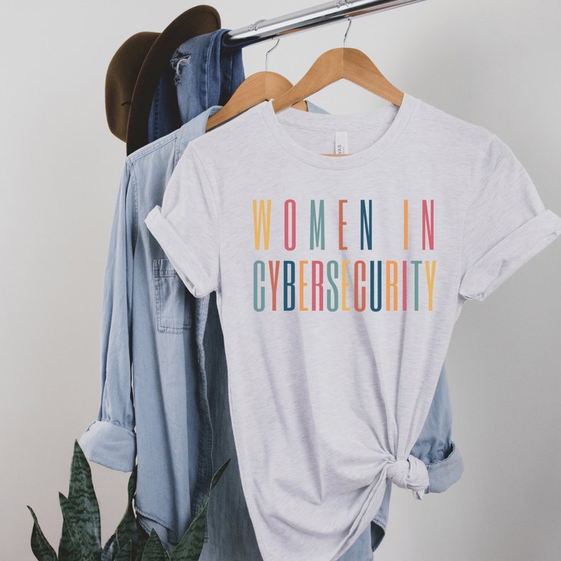 light gray unisex t-shirt that says women in cybersecurity in all capital, multicolored letters, this is a cyber security gift idea