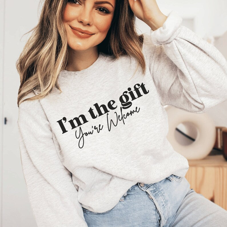 light gray unisex sassy sweatshirt that says i'm the gift you're welcome in black lettering