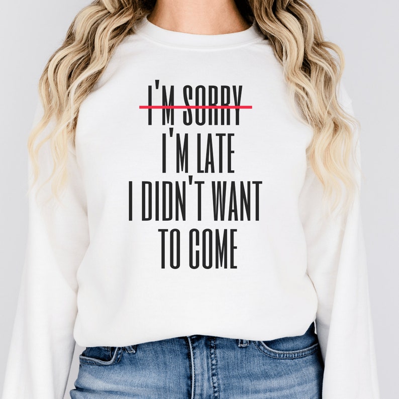 white unisex introvert sweatshirts that say im sorry im late i didnt want to come with the words im sorry crossed out with a red line