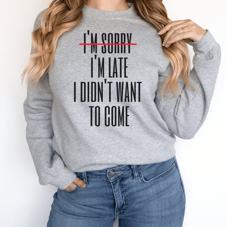gray unisex introvert sweatshirts that say im sorry im late i didnt want to come with the words im sorry crossed out with a red line