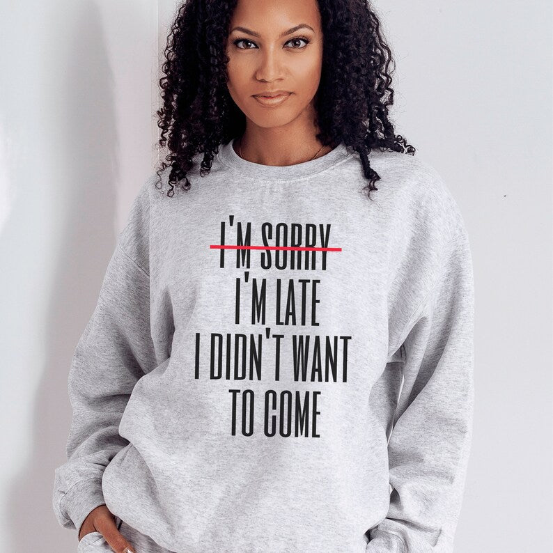 light gray unisex introvert sweatshirts that say im sorry im late i didnt want to come with the words im sorry crossed out with a red line