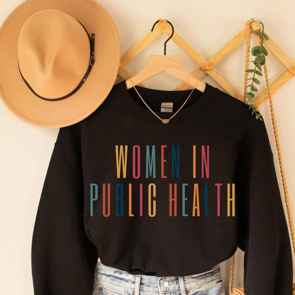 black unisex sweatshirt that says women in public health in all capital multicolored letters. This is public health apparel.
