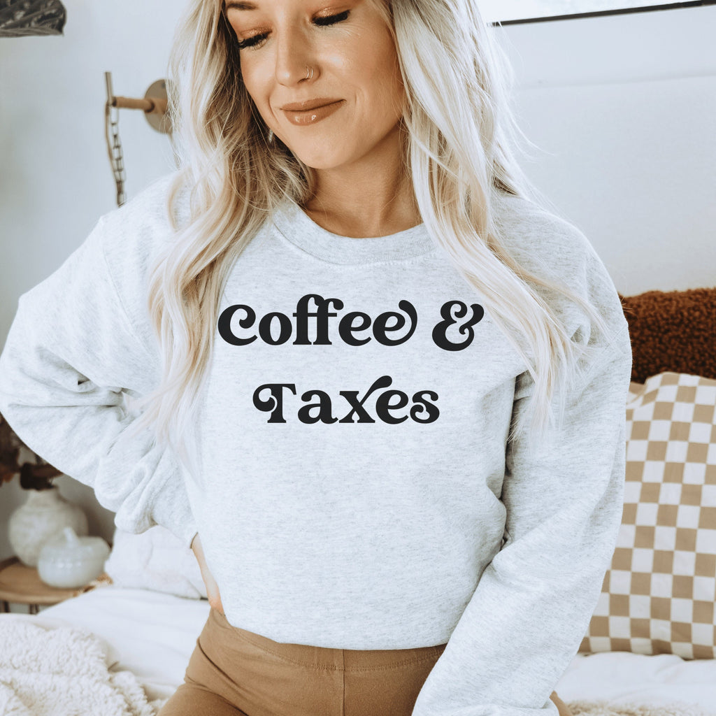 light gray unisex gift for accountant graduate sweatshirt that says coffee & taxes