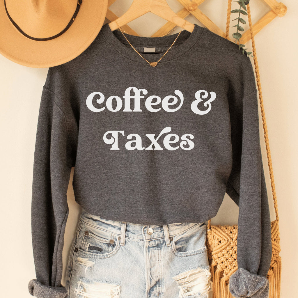 dark gray heather unisex gift for accountant graduate sweatshirt that says coffee & taxes