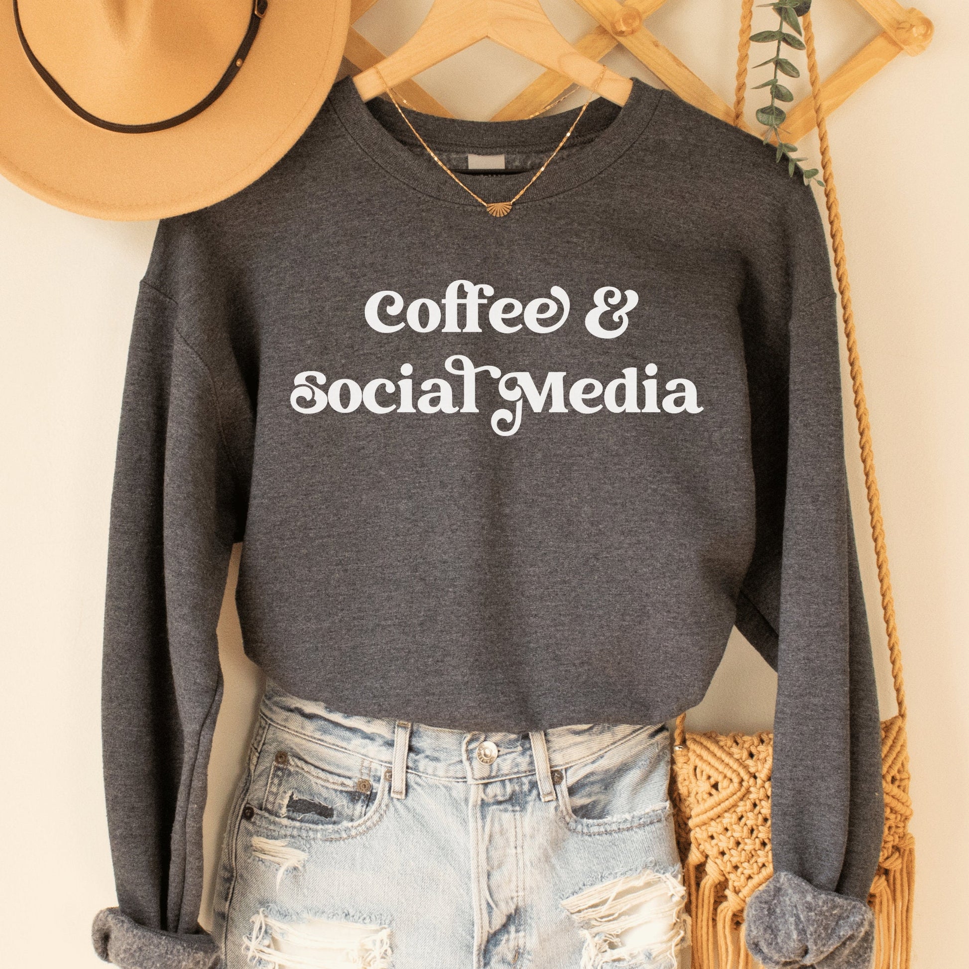 dark heather gray unisex sweatshirt that says coffee and social media, great gifts for social media managers