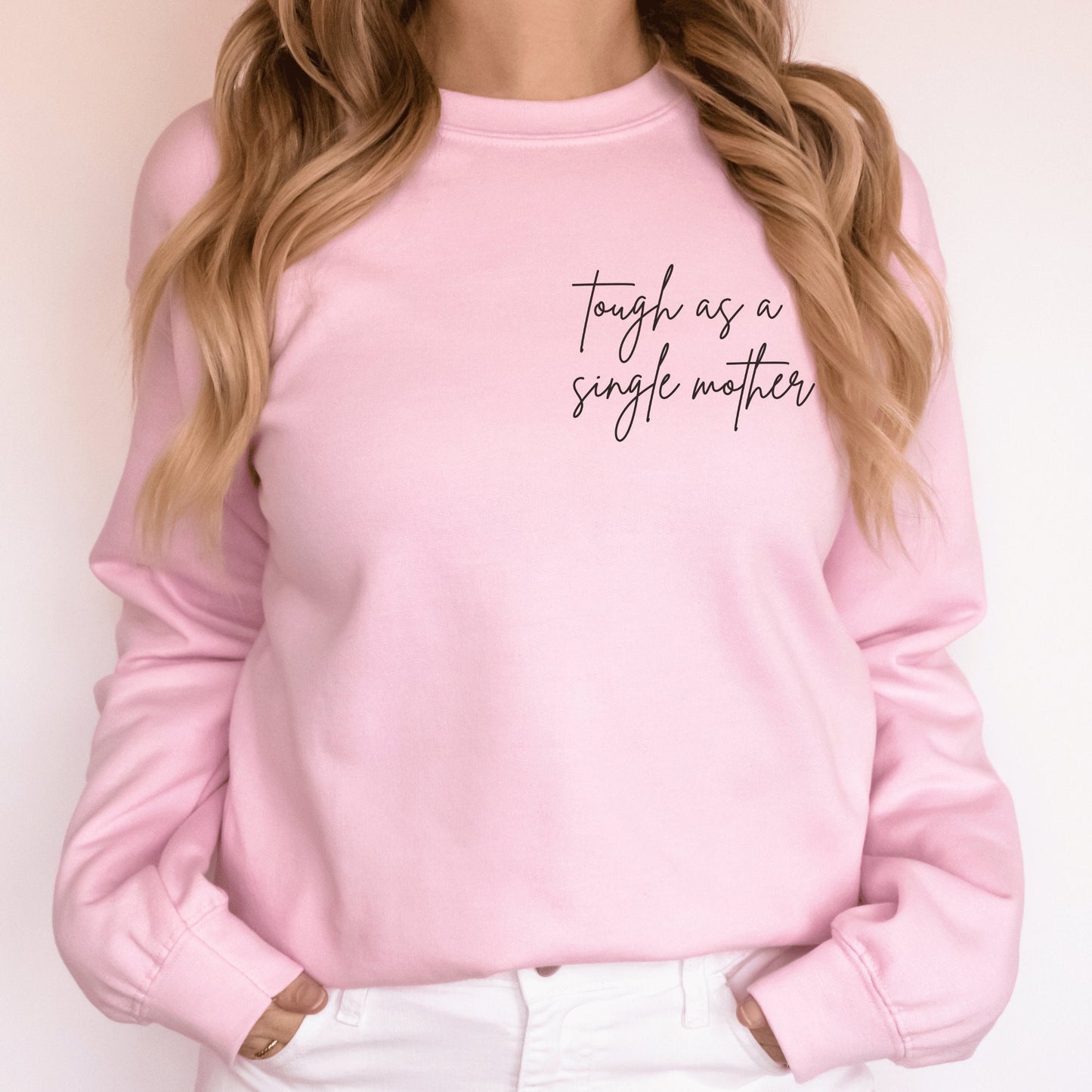 pink sweatshirt that says "tough as a single mother" on the pocket area (no pocket) in cursive font. Our sweatshirts are the best gifts for single moms