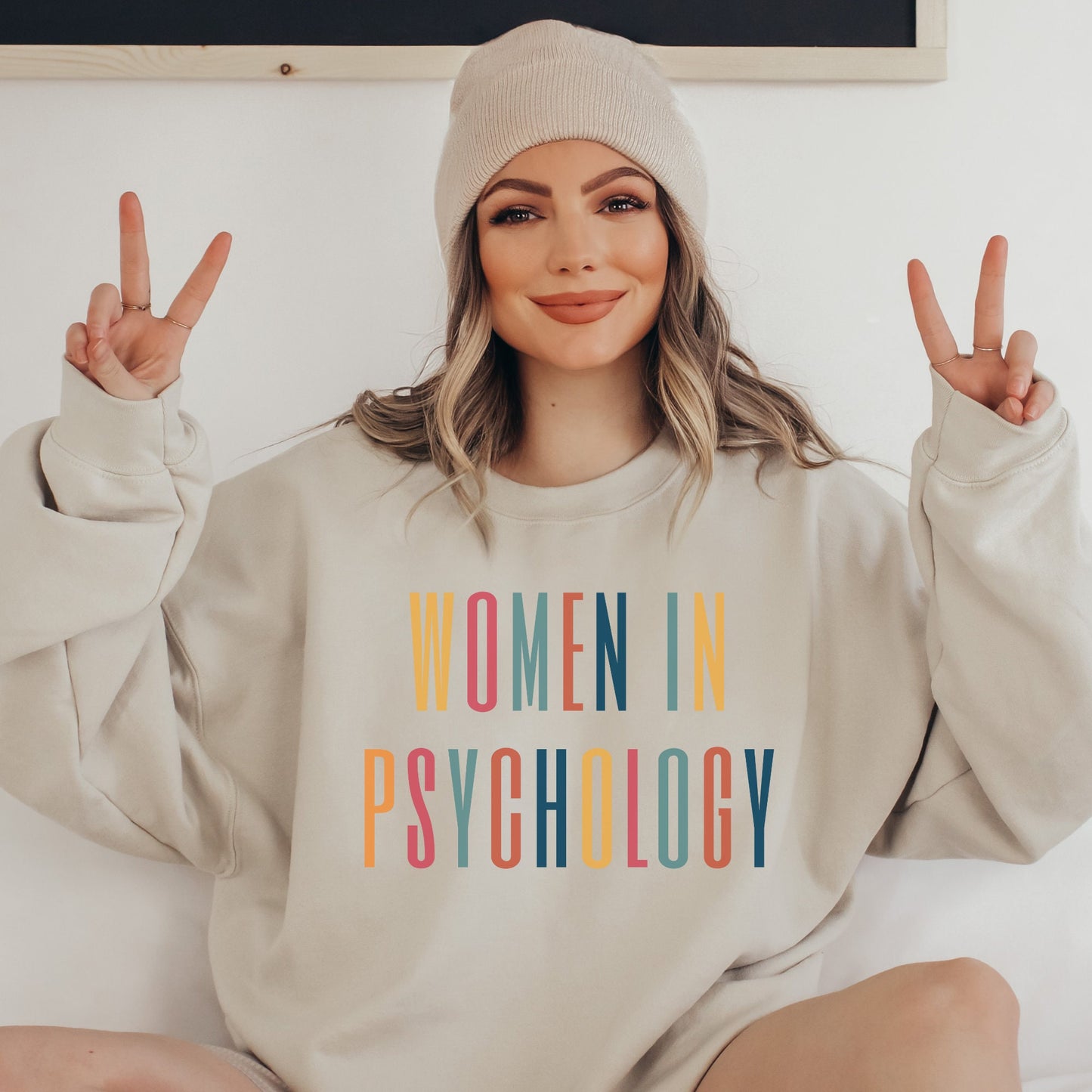 beige unisex psych sweatshirt that says "women in psychology" in all capital, multicolored letters