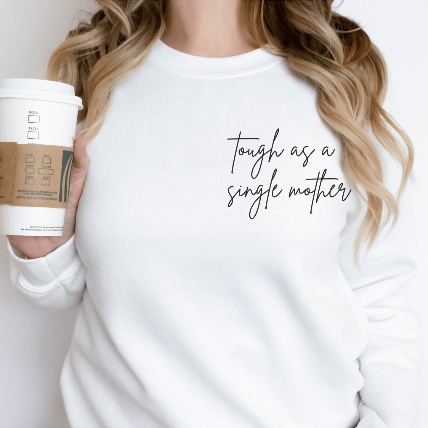 white unisex sweatshirt that says "tough as a single mother" on the pocket area (no pocket) in cursive font. Our sweatshirts are the best gifts for single moms 