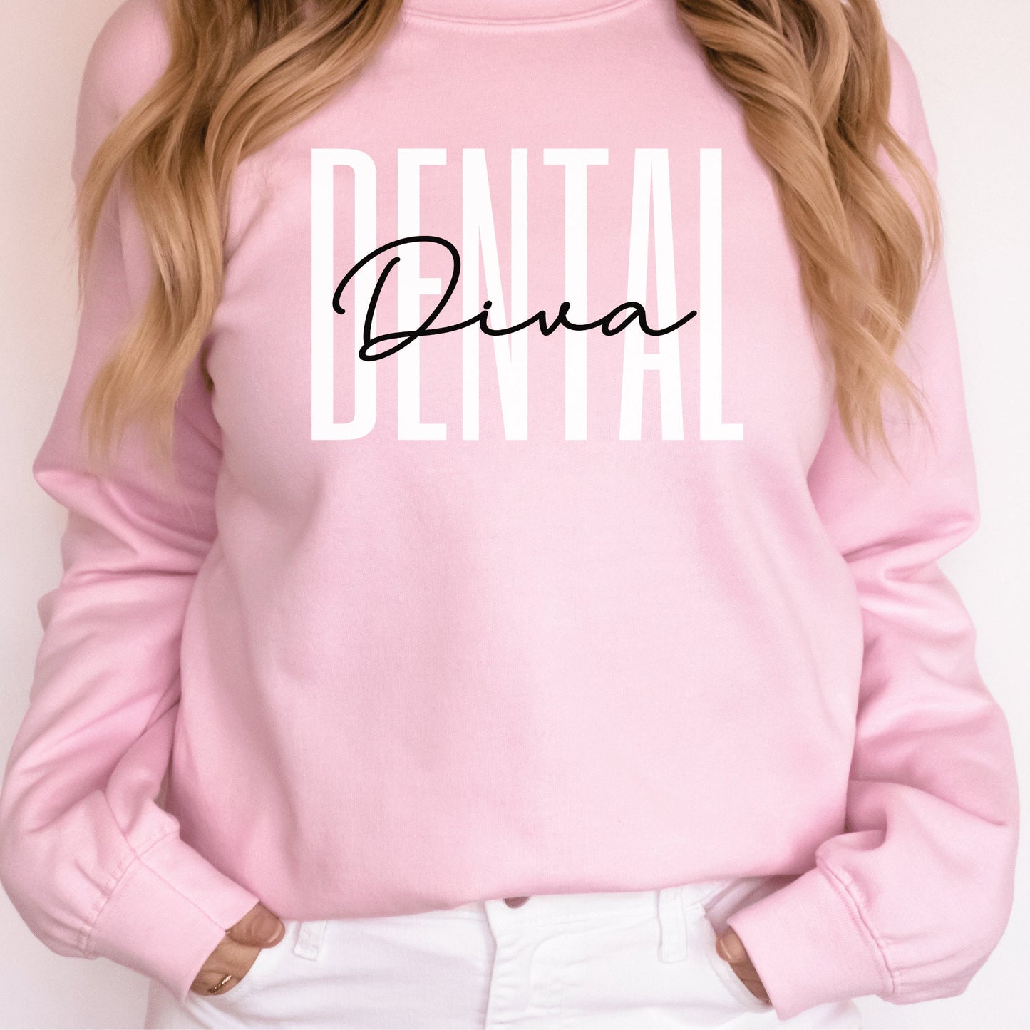 pink unisex dental hygienist sweatshirt that says dental in all white capital letters with the word diva in black script overlaying the word dental