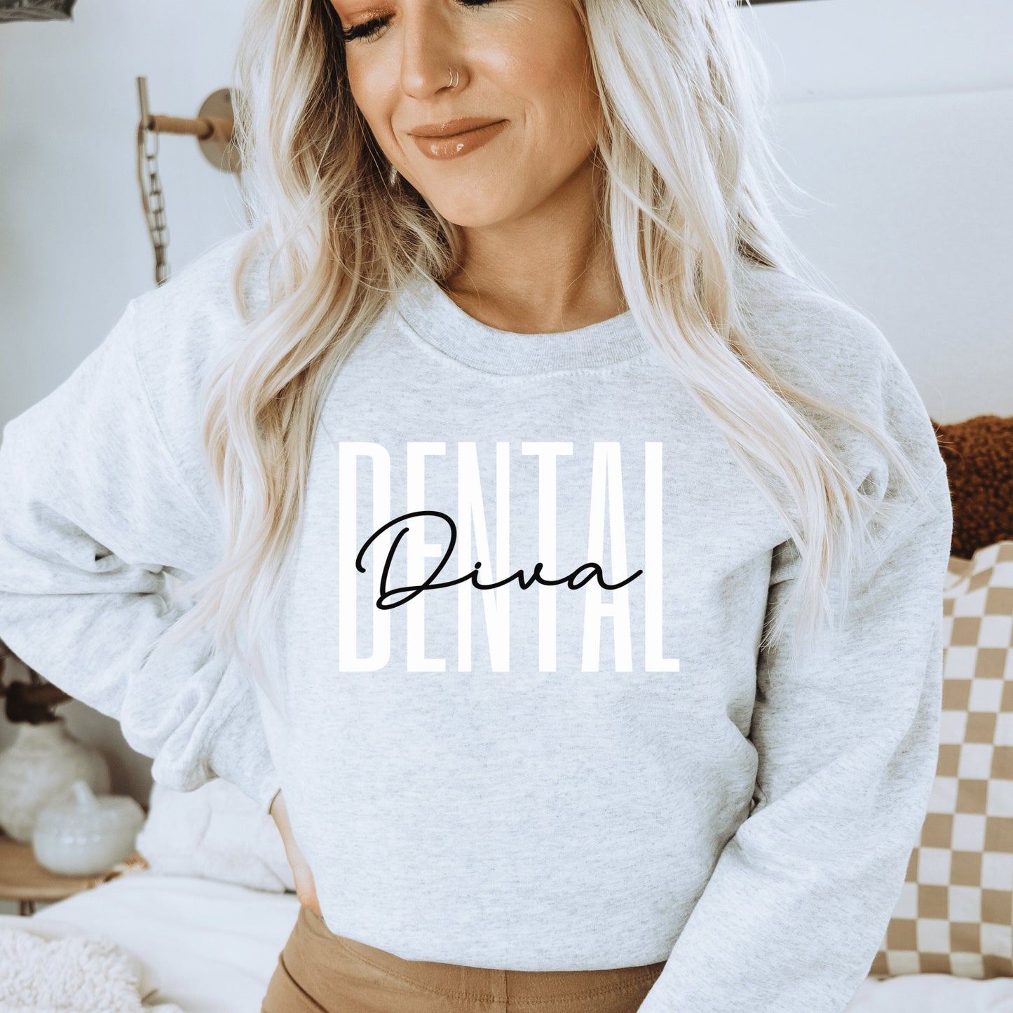 light gray unisex dental hygienist sweatshirt that says dental in all white capital letters with the word diva in black script overlaying the word dental