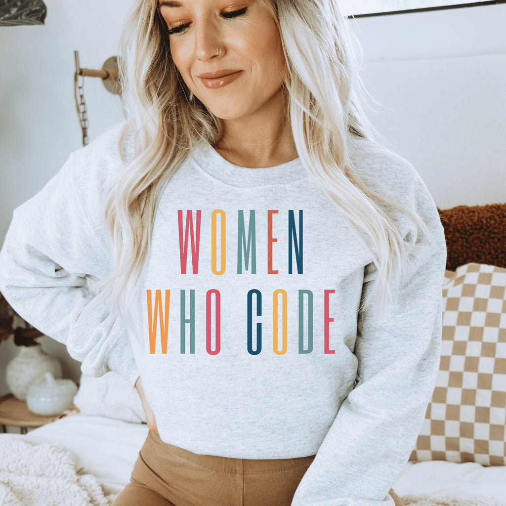 light gray unisex coder sweater that says "women who code" in all capital, multicolor letters