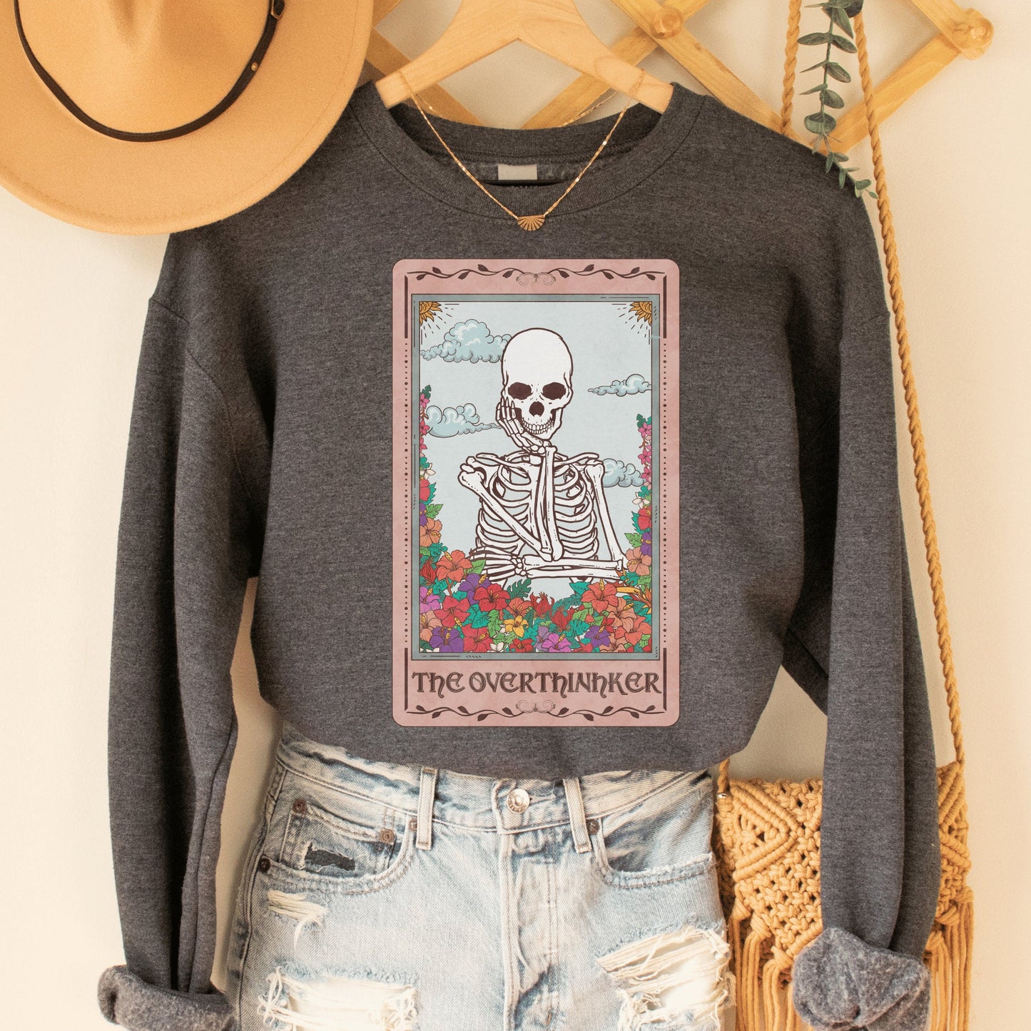 dark gray heather unisex overthinker sweatshirt with a graphic of a tarot card with skeleton graphic that says the overthinker
