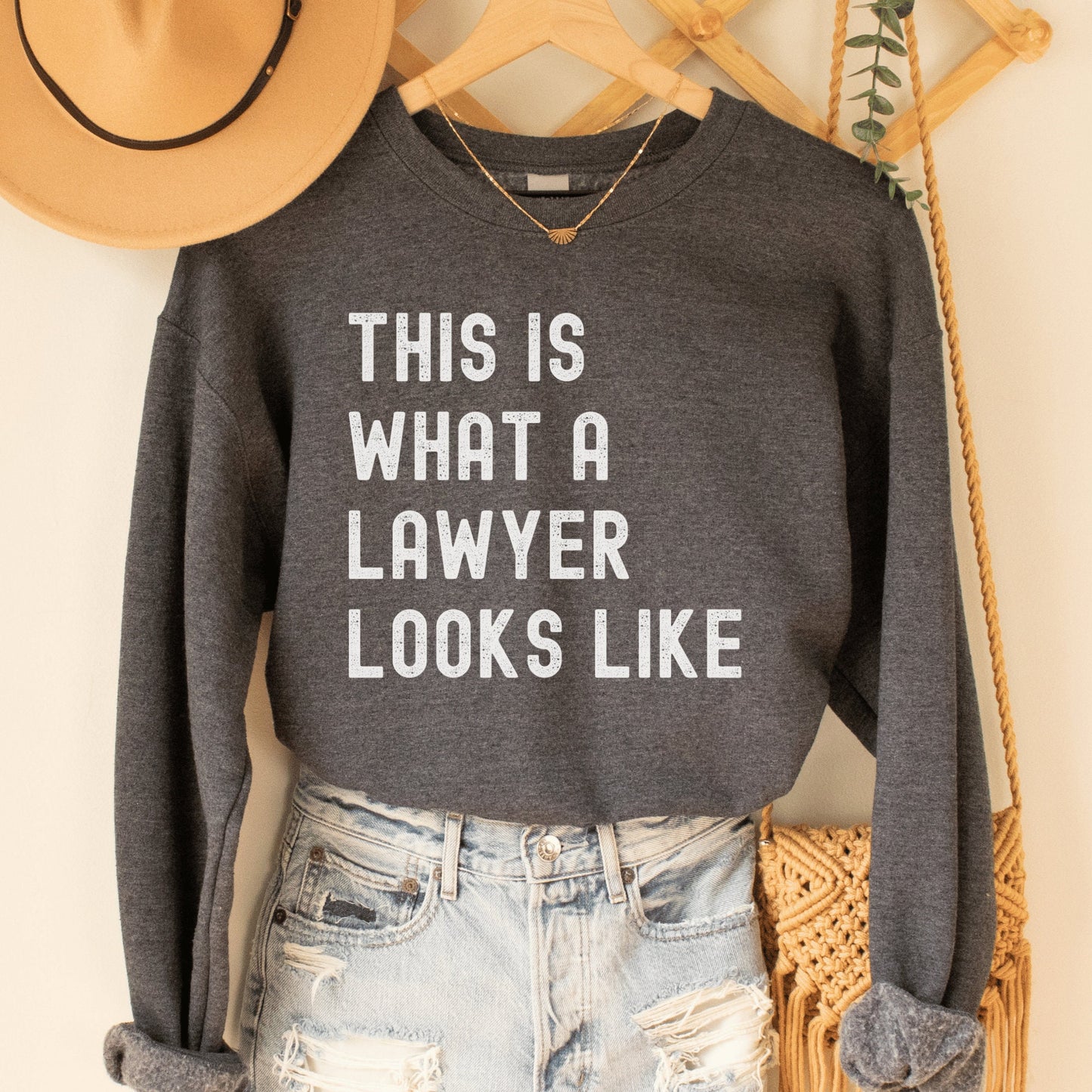 dark gray heather unisex lawyer sweatshirt that says this is what a lawyer looks like