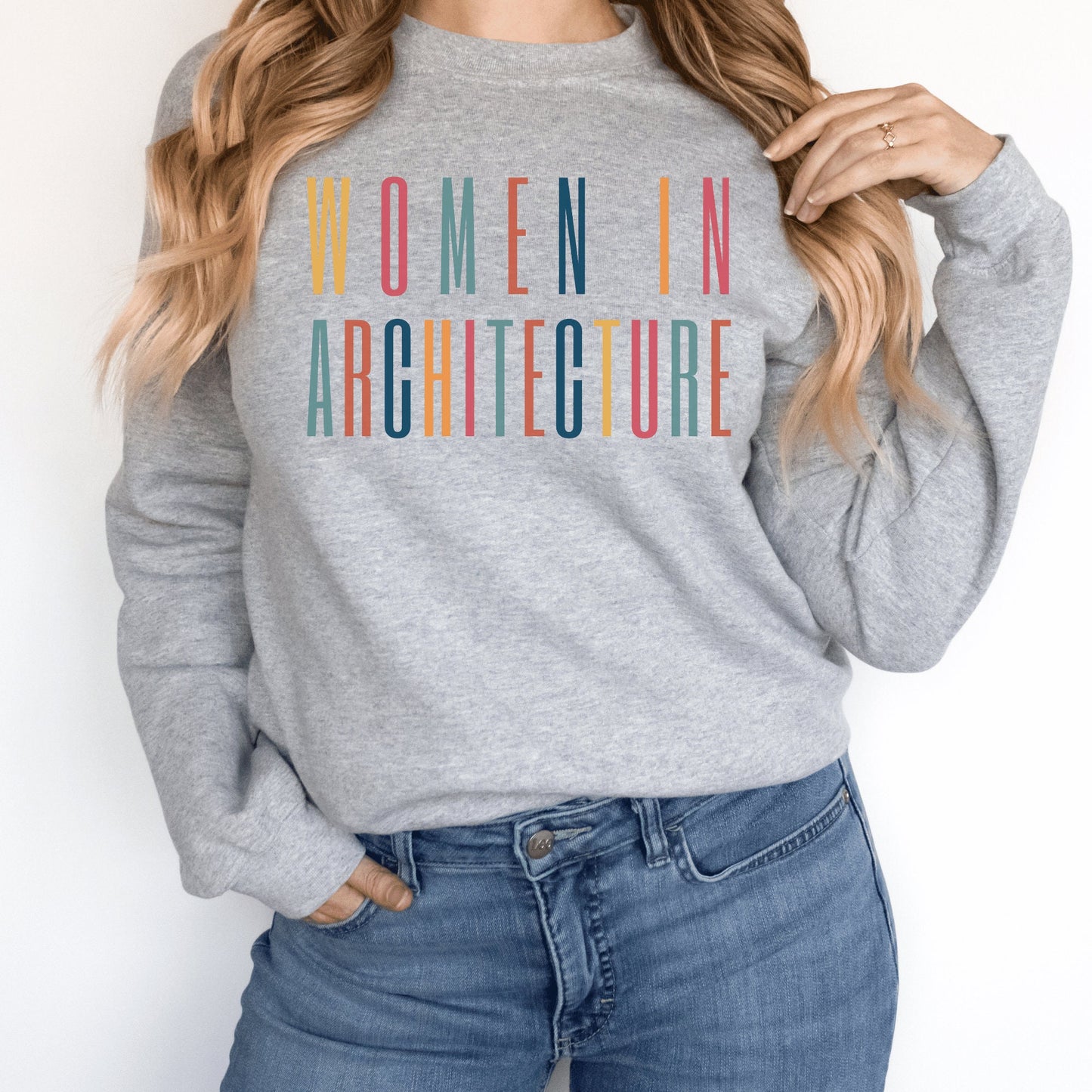 gray  unisex sweatshirt with women in architecture written in capital, multicolored letters. Our apparel makes great architecture student gifts