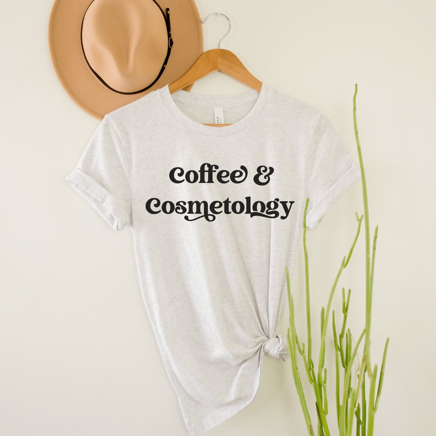 light gray unisex t-shirt and cosmetology gift ideas that says coffee and cosmetology across the front in stylish font