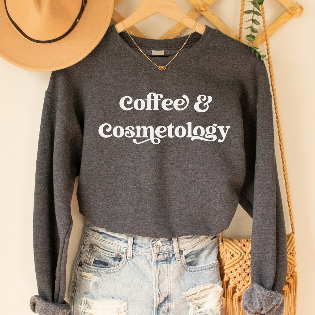 dark gray heather unisex sweatshirt that says coffee and cosmetology in stylish font, cosmetology gift ideas