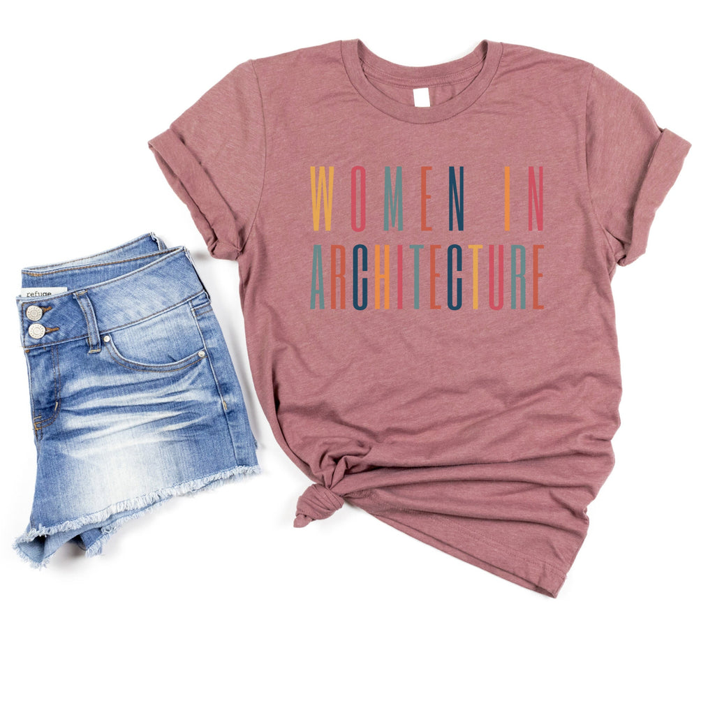 heather purple or plum colored  unisex t-shirt with multicolored lettering that says women in academia.