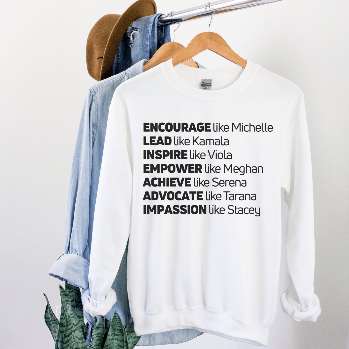 white unisex melanin sweatshirt that says encourage like michelle, lead like kamala, inspire like viola, empower like meghan, achieve like serena, advocate like tarana, impassion like stacey