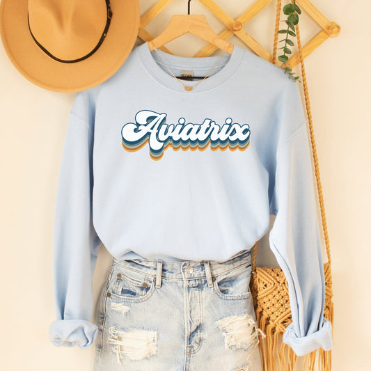 Light blue unisex sweatshirt with retro styled lettering with shadowing that says Aviatrix, best Female Pilot Shirts