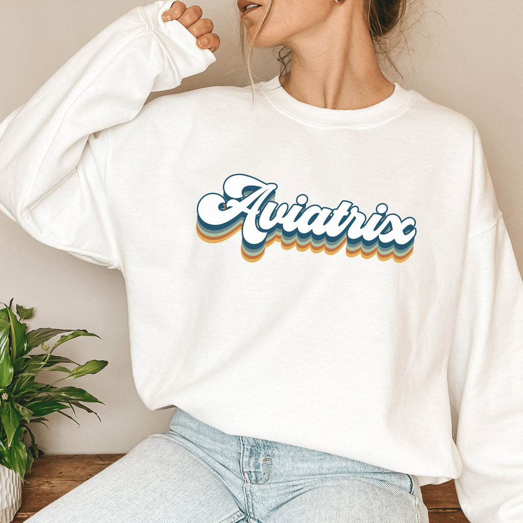 white unisex sweatshirt with retro styled lettering with shadowing that says Aviatrix, female pilot shirts
