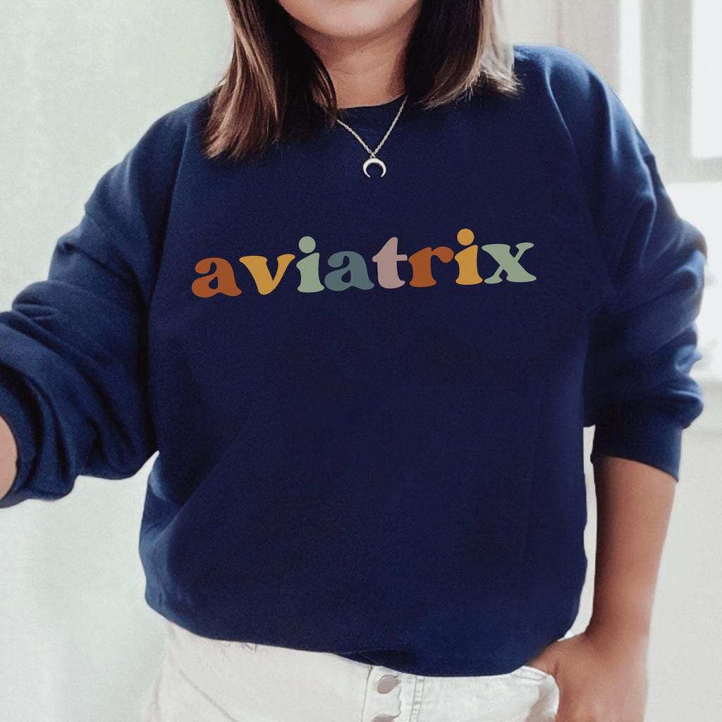 navy blue unisex sweatshirt with multicolored lettering with shadowing that says Aviatrix