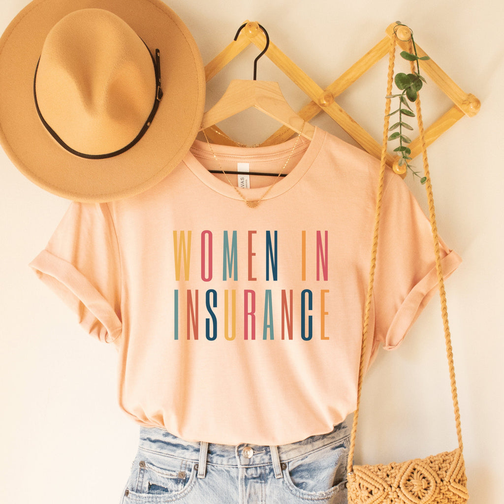 heather peach unisex t-shirt that says "women in insurance" in all capital, multicolored letters, our t-shirts make great gifts for insurance agents
