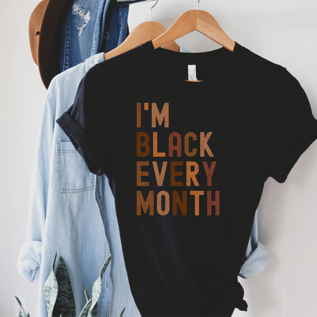 black unisex "i am black every month" shirt with lettering in all capital, multicolored shades of brown