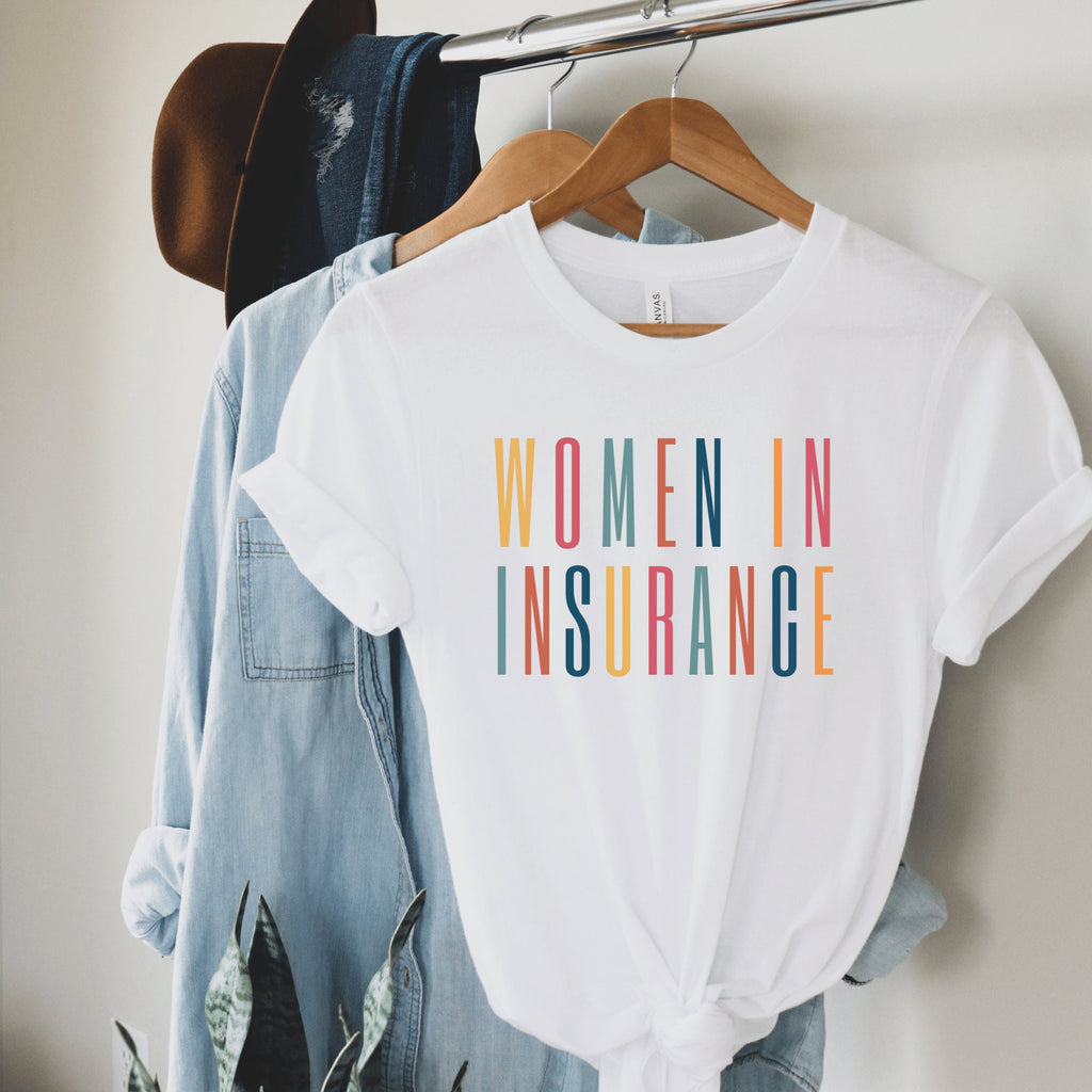white unisex t-shirt that says "women in insurance" in all capital, multicolored letters, our t-shirts make great gifts for insurance agents