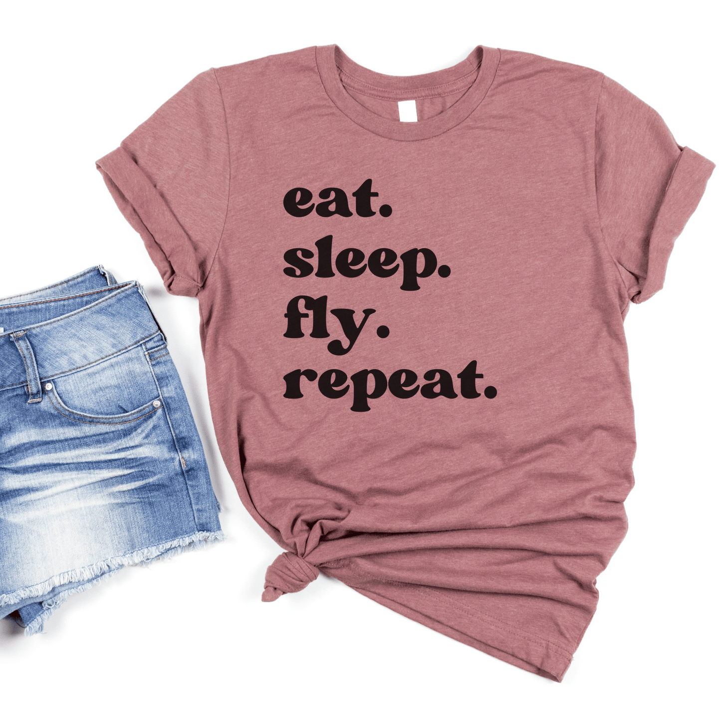 heather mauve unisex wanderlust t-shirt that says eat. sleep. fly. repeat.